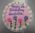 light pink frosting w/pink & purple daisies