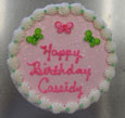 light pink frosting w/green & pink butterflies